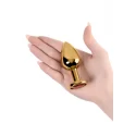 Gold anal plug TOYFA Metal with red round-shaped gem, length 7,8 cm, diameter 2,2-3,5 cm, weight 95 gr